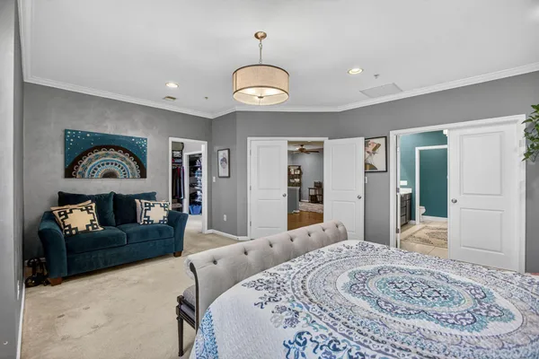 a bedroom with a bed and a chandelier