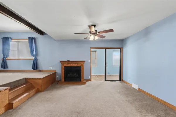 a view of livingroom with furniture fan and window