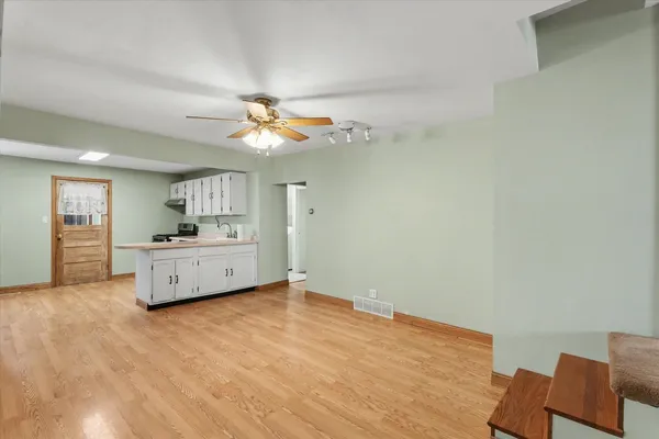 a view of a bedroom with furniture and a chandelier fan
