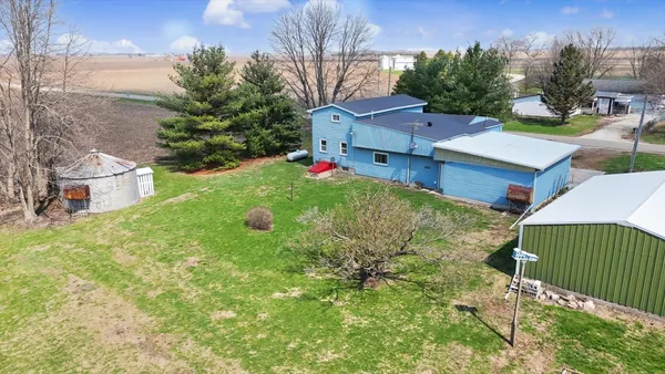 an aerial view of a house with a yard and lake view