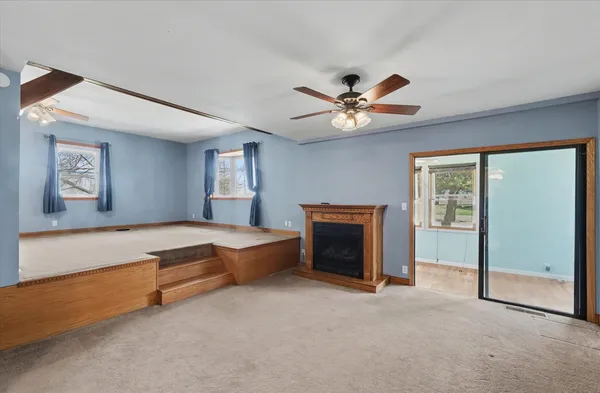a spacious bedroom with a bed and a ceiling fan