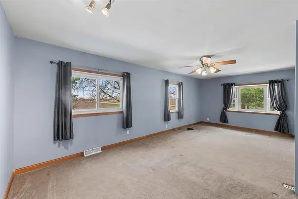 a view of an empty room with windows