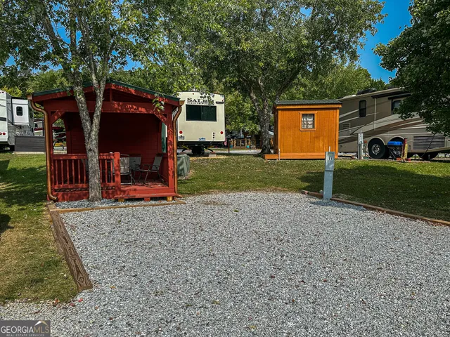 a view of a house with backyard and a tree