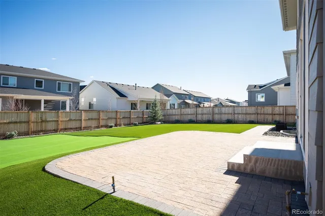 a view of a house with a yard and sitting area