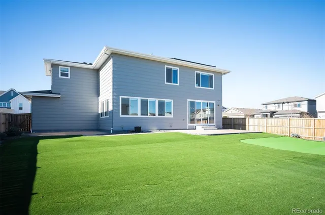a front view of a house with a garden and parking