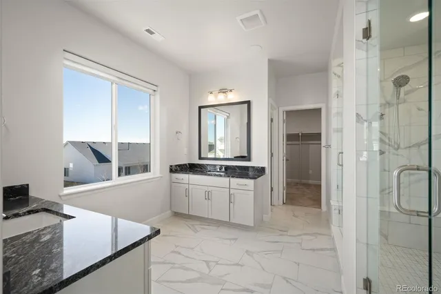 a kitchen with stainless steel appliances granite countertop a sink and a refrigerator