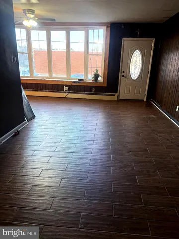 a view of room with window and wooden floor