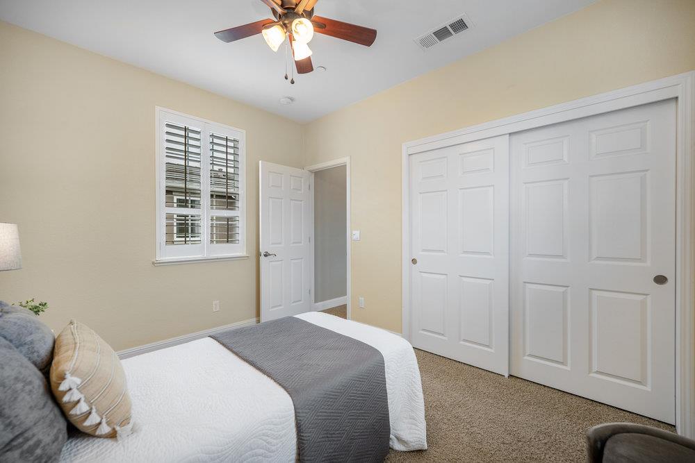 5813 Cajon Way Gilroy, CA 95020 - Photo 16 of 55 a bedroom with a bed and a chandelier