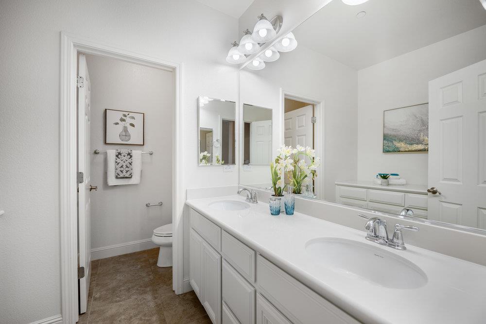 5813 Cajon Way Gilroy, CA 95020 - Photo 19 of 55 a bathroom with a sink a toilet and a mirror