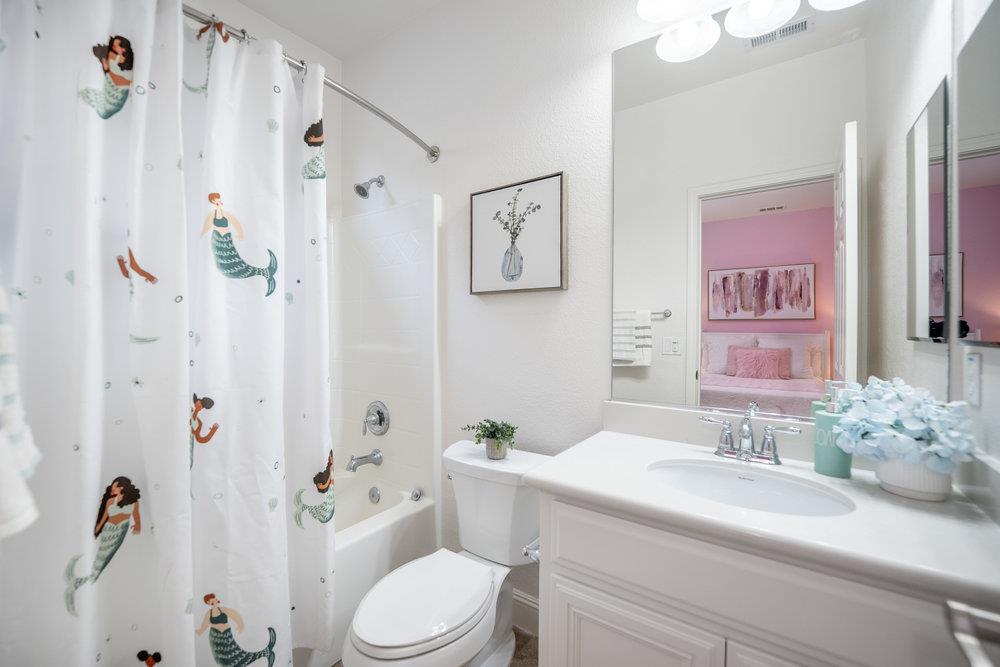 5813 Cajon Way Gilroy, CA 95020 - Photo 25 of 55 a bathroom with a sink a toilet and shower curtain