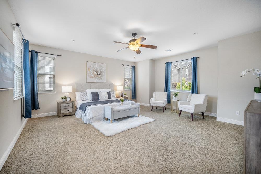 5813 Cajon Way Gilroy, CA 95020 - Photo 28 of 55 a bedroom with bed and a chandelier