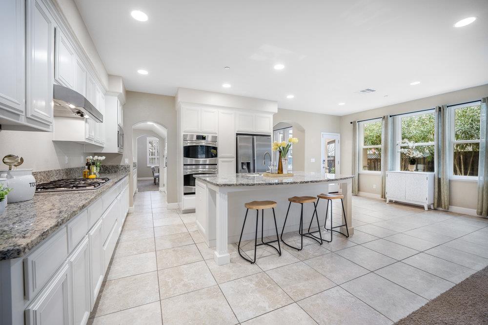 5813 Cajon Way Gilroy, CA 95020 - Photo 5 of 55 a large kitchen with kitchen island granite countertop lots of counter space and windows