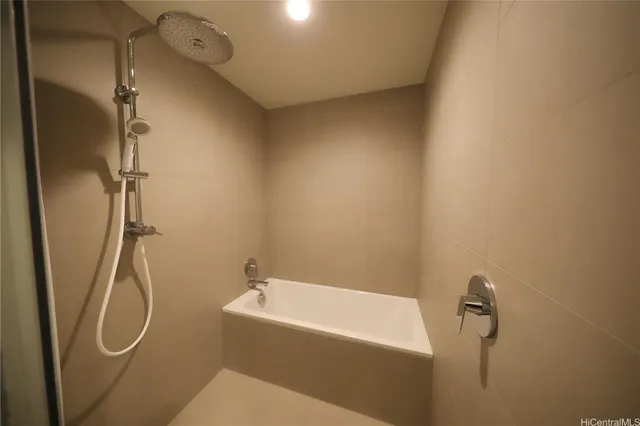 a bathroom with a bathtub and shower