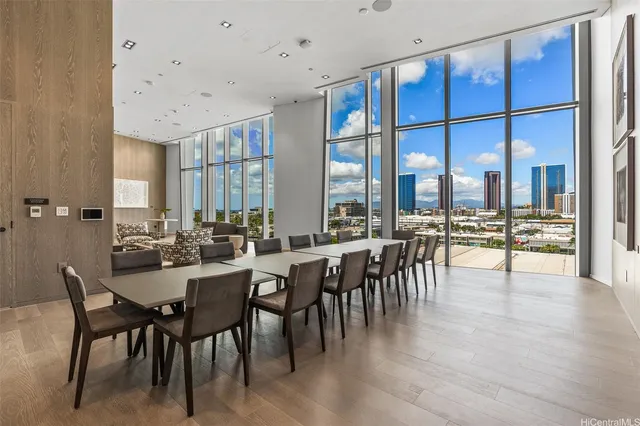 a very nice looking dining room with a large dining table and a large window with wooden floor
