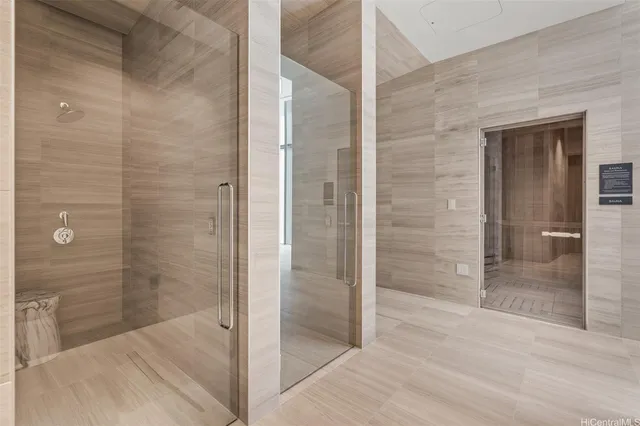 a bathroom with a shower and a glass door