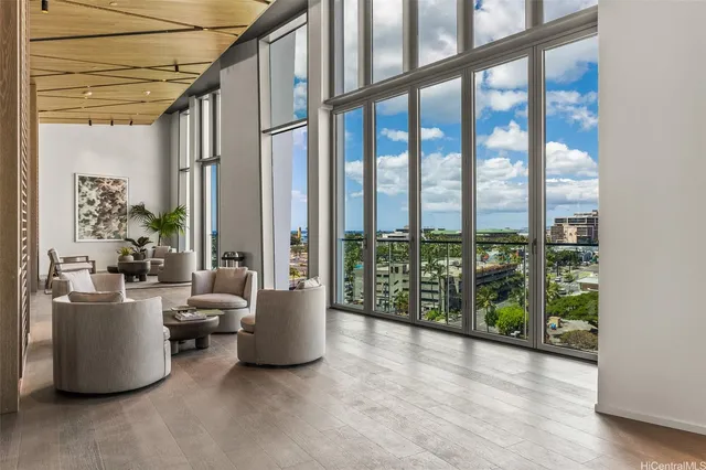 a living room with furniture and a floor to ceiling window
