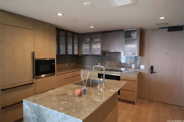 a kitchen with stainless steel appliances granite countertop a sink a stove and a refrigerator