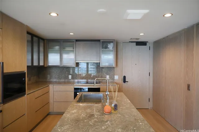 a kitchen with a sink stainless steel appliances and cabinets