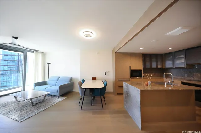 a living room with kitchen island furniture and a kitchen view