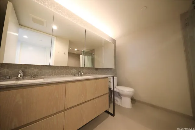 a bathroom with a sink a toilet and mirror