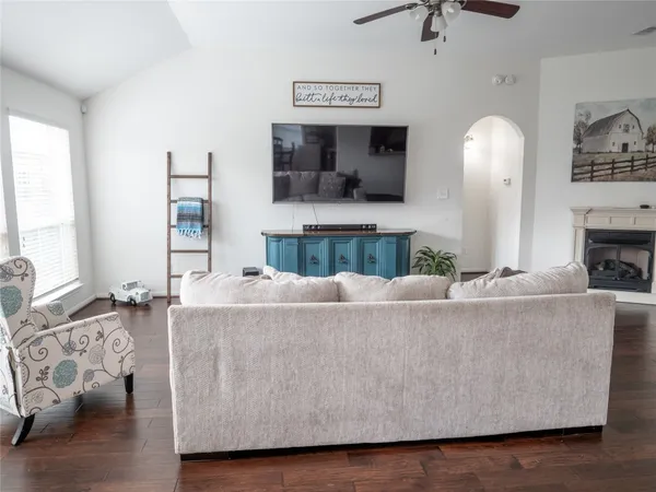a living room with furniture and a fireplace