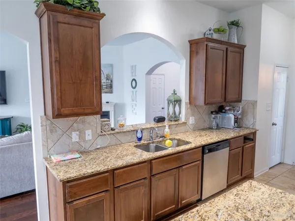 a bathroom with a granite countertop double vanity sink and mirror
