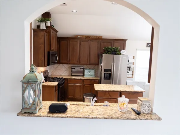 a kitchen with a stove and a refrigerator