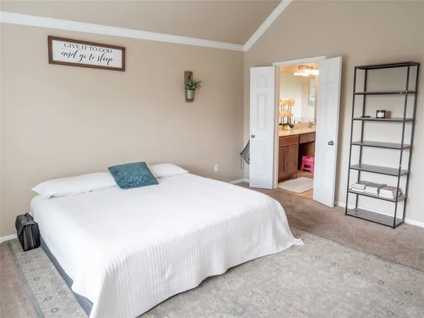 a bedroom with a bed and a view of bathroom