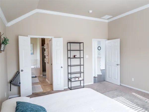 a bedroom with a bed and a dresser