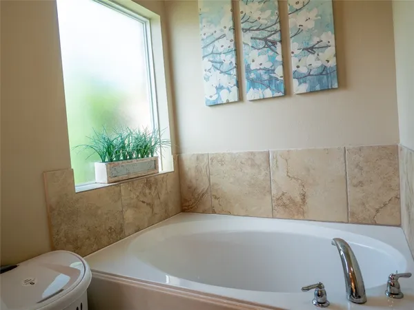 a bathroom with a toilet and a window