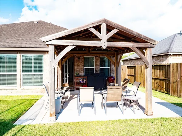a view of a house with swimming pool and sitting area