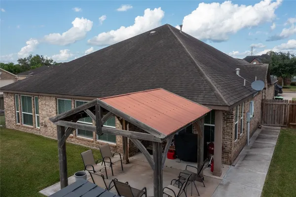 a roof deck with table and chairs