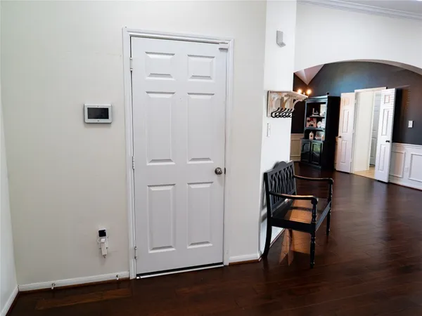 an empty room with wooden floor table and chairs