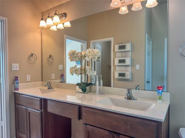 a bathroom with a sink double vanity and a mirror