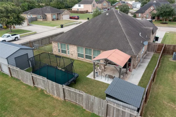 a view of a patio with chairs next to a yard