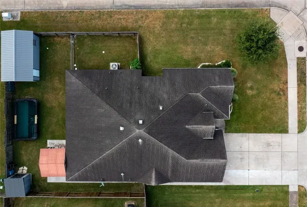 an aerial view of a house with a yard