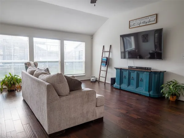 a living room with furniture and a flat screen tv