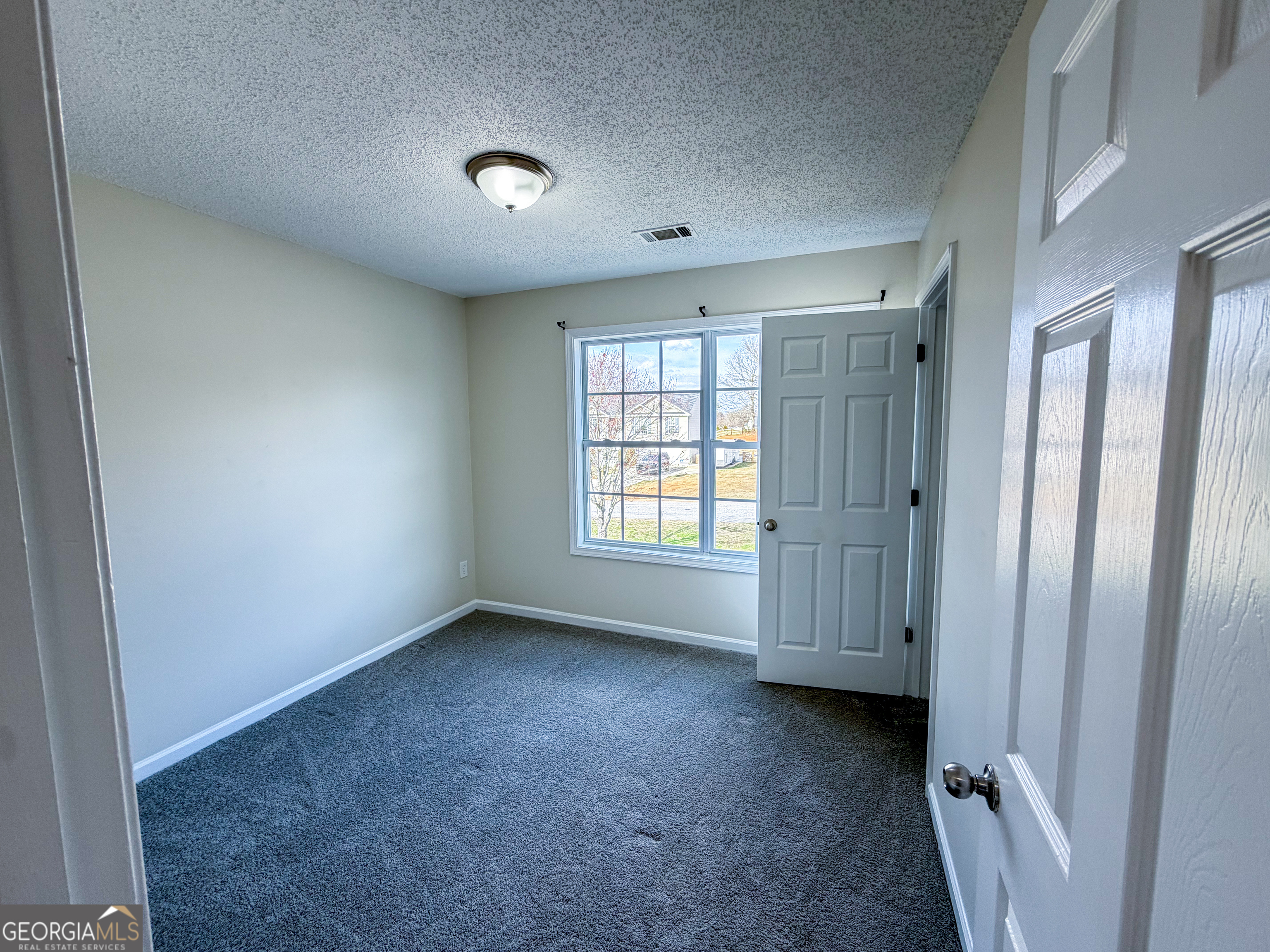 1119 Hummingbird Way Winder, GA 30680 - Photo 11 of 38 an empty room with windows