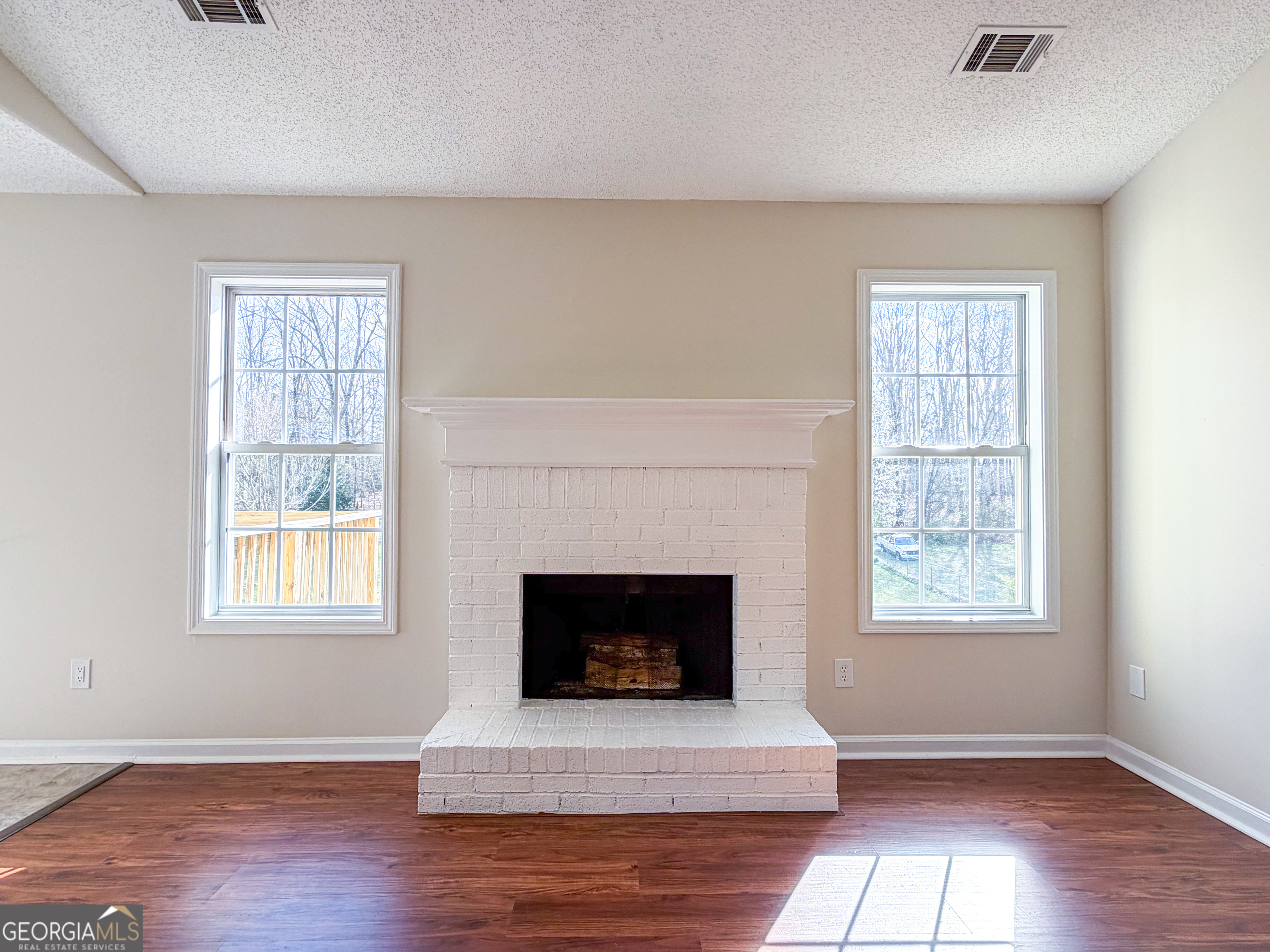1119 Hummingbird Way Winder, GA 30680 - Photo 17 of 38 a living room with a fireplace and window