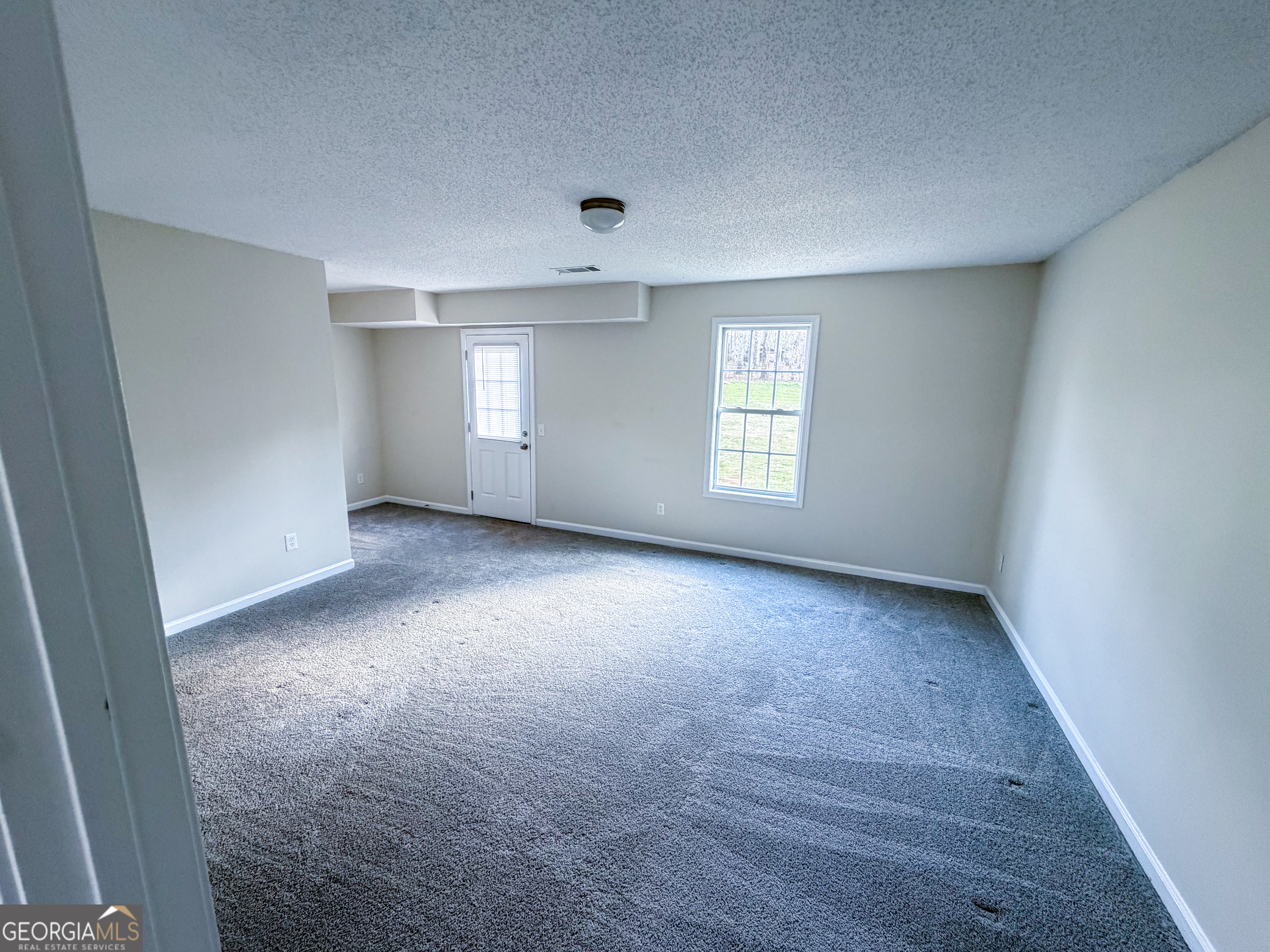 1119 Hummingbird Way Winder, GA 30680 - Photo 27 of 38 an empty room with windows