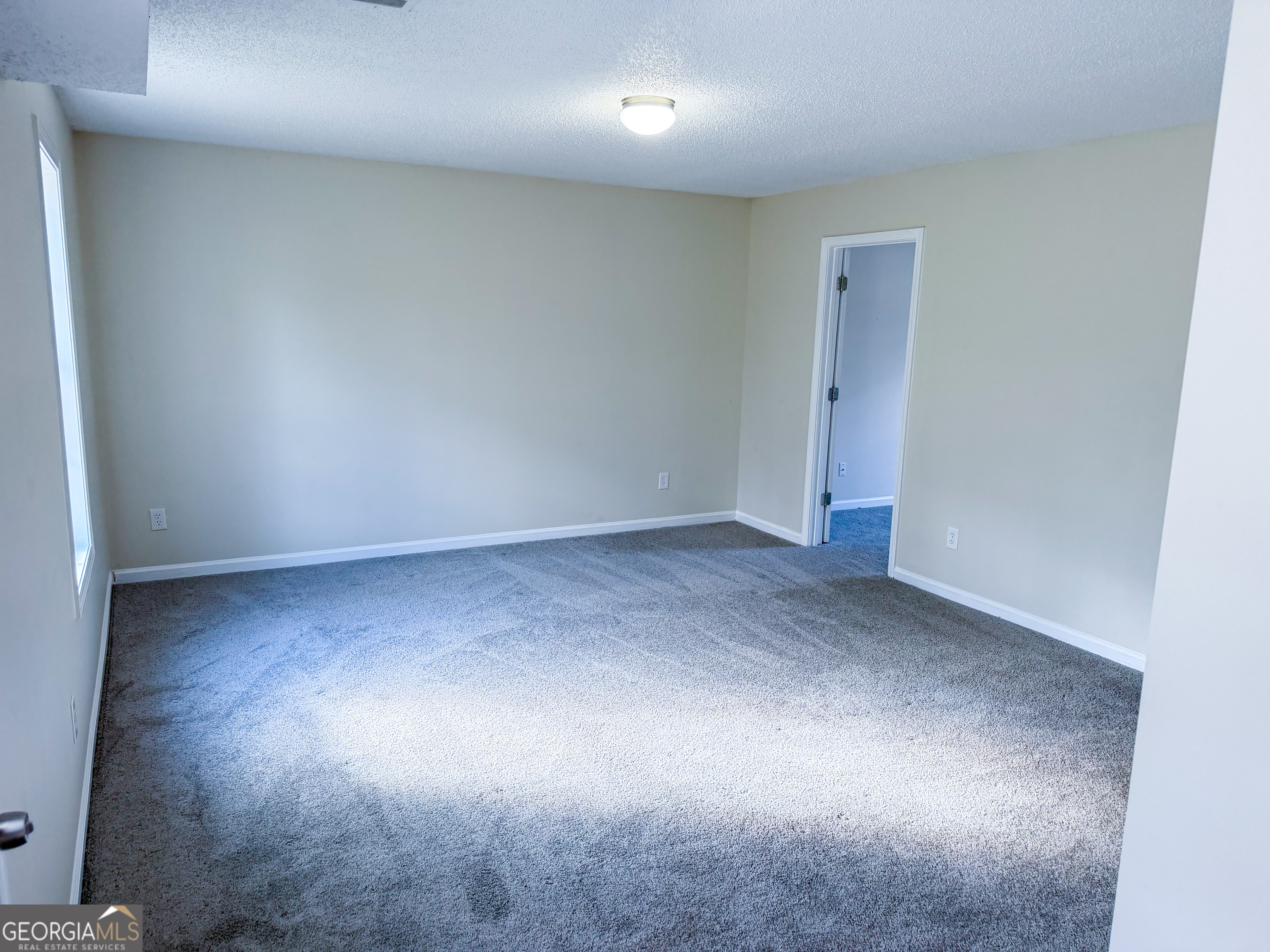 1119 Hummingbird Way Winder, GA 30680 - Photo 31 of 38 an empty room with a natural light