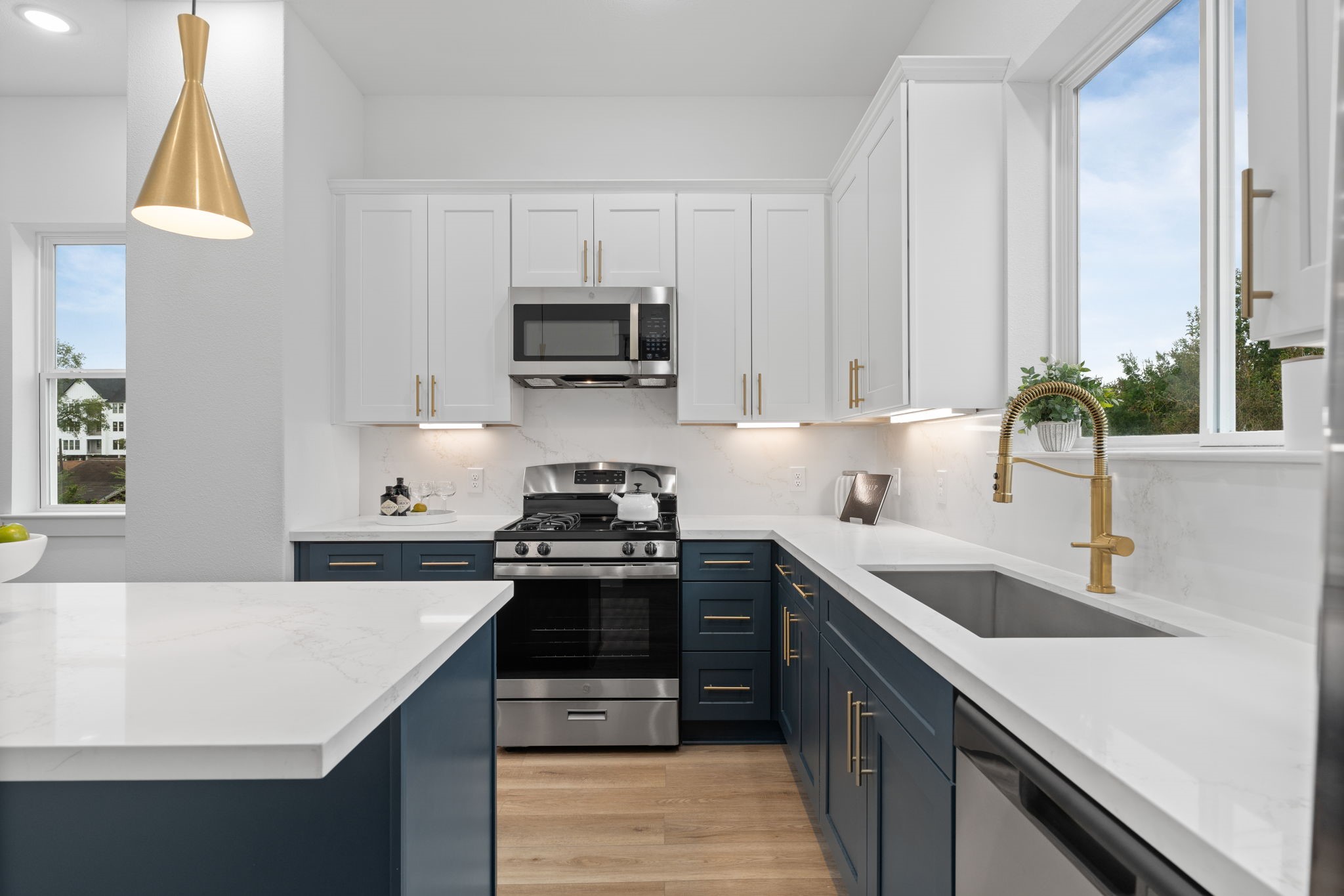 717 Janisch Road, Unit I Houston, TX 77018 - Photo 10 of 19 a kitchen with kitchen island granite countertop a sink a stove and a wooden floors