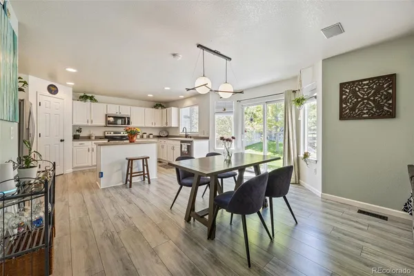 a view of a dining room with furniture and wooden floor