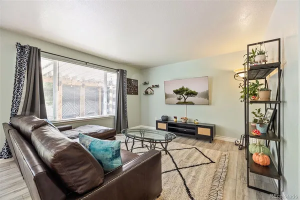a living room with furniture and floor to ceiling window