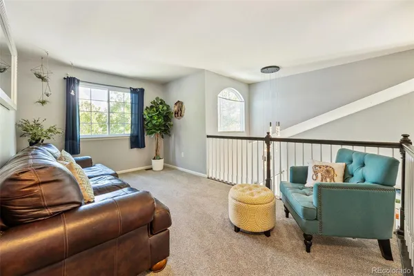 a bedroom with a couch and a window