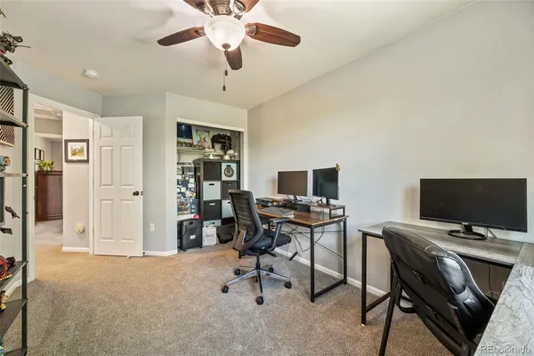 a view of a livingroom with workspace and a window