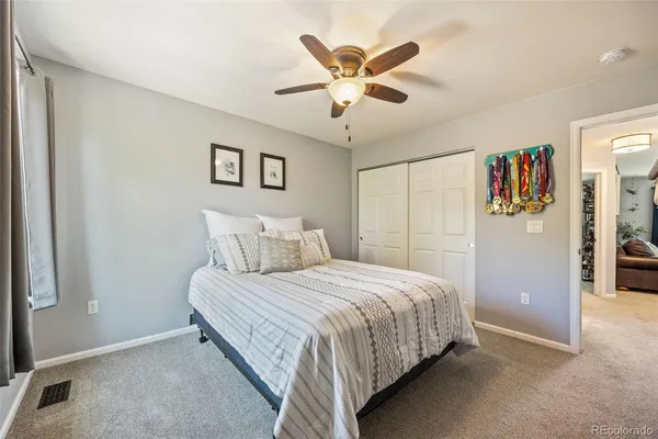 a bedroom with a large bed and a chandelier