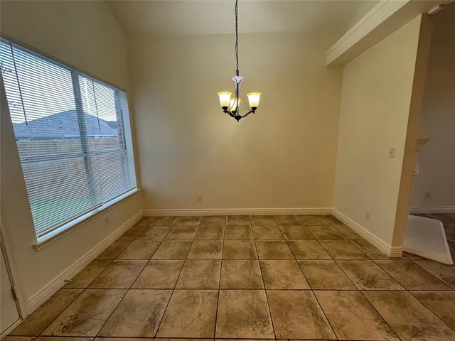 a kitchen with stainless steel appliances granite countertop a stove top oven a sink and a refrigerator