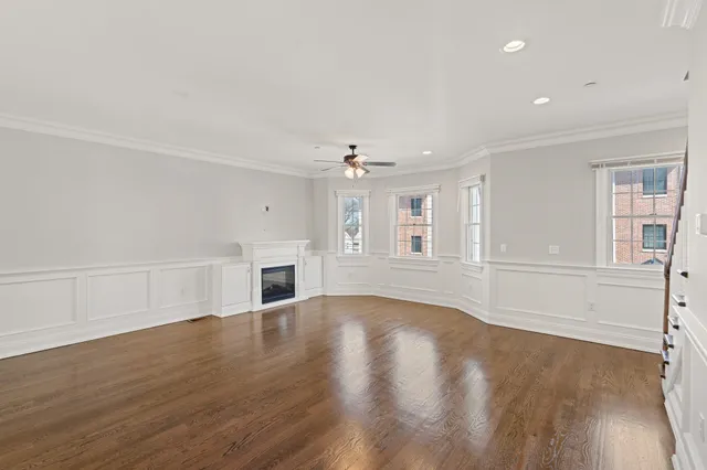 a view of staircase with wooden floor and white walls