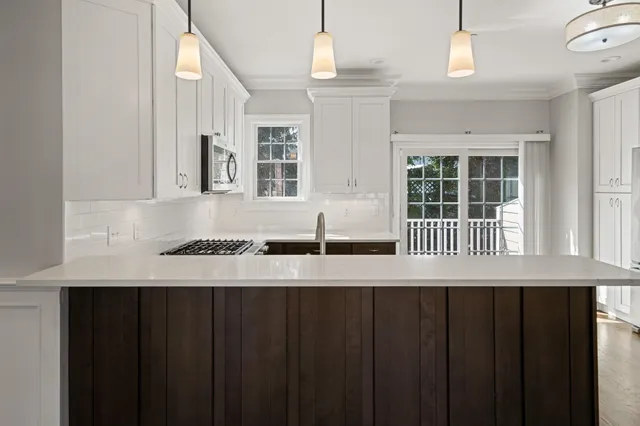 a view of a kitchen with wooden floor and a window